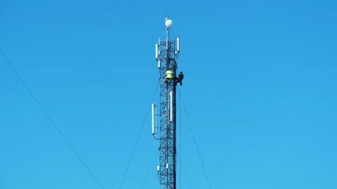 Two workmen on cell tower. Repairmen install new cable and equipment Stock Footage 317194958
