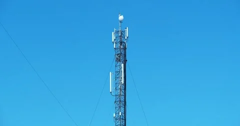 Two workmen on cell tower. Repairmen install new cable and equipment Stock Footage 319905632