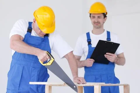 Two workmen with saw and folder Stock Photos