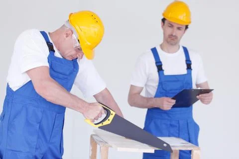 Two workmen working together Stock Photos