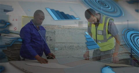 Two workshop workers leaning over sheets marking cut lines in factory, showing Stock Footage 308151881