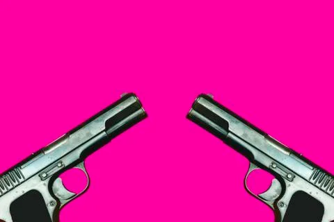 Two world war 2 guns facing each other on a pink background Stock Photos