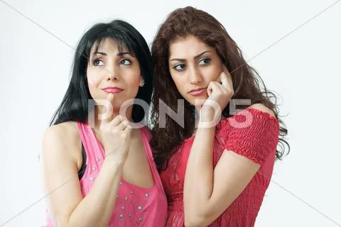 Two worried women, of multiethnic or latino origin Stock Photos
