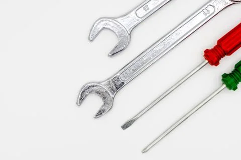 Two wrenches and a screwdriver are placed together on a white isolate. Stock Photos
