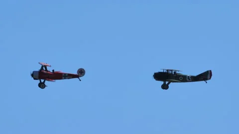 Two WWI planes fly together in clear skies Video stock 196727493