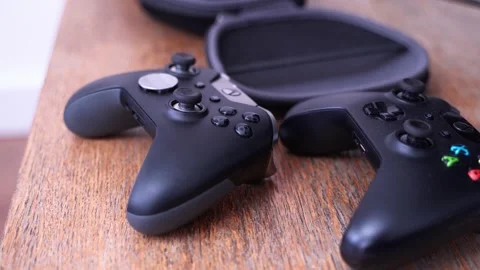 Two Xbox One videogame controllers on a table, medium to close up shot Stock Footage 151924346
