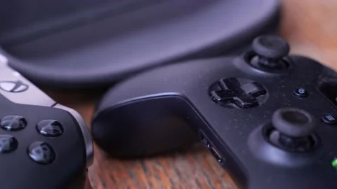 Two Xbox One videogame controllers on table, close up pan right Stock Footage 151924383