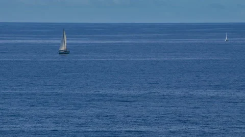 Two yachts on a flat surface of the ocean. Peaceful and joyful pastime. Stock Footage 169532263
