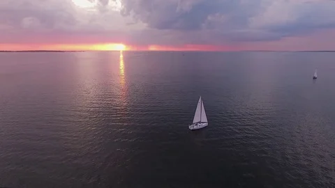 Two yachts at sunset on the high seas in a romantic dream trip.Pink sky. Stock Footage 73029863
