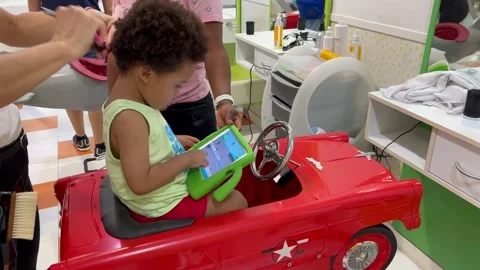 Two year old adorable african european child having his first hair cut in Stock Footage 210403238