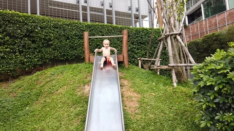 Two-year-old blond boy with great joy and fun down the hill  Stock Footage 104848871