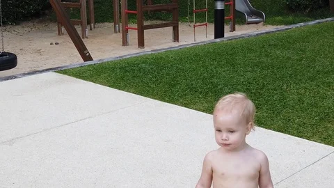  a two-year-old blond boy with a serious face leaves the frame. close up, Stock Footage 104848958