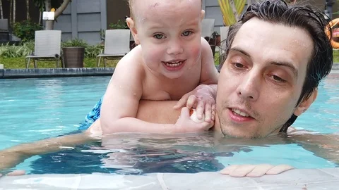 Two-year-old blond boy with his father with great joy  Stock Footage 104849268