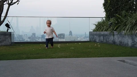 Two-year-old blond boy runs along the path, Stock Footage 104950182