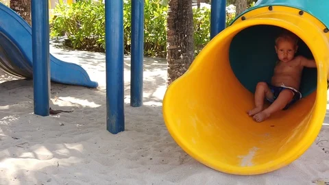  a two-year-old blond boy in a Playground located on the beach. Stock Footage 118364373