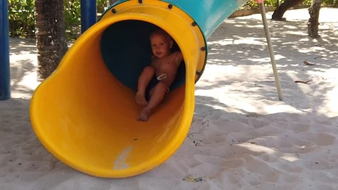  a two-year-old blond boy in a Playground located on the beach. Stock Footage 118365361