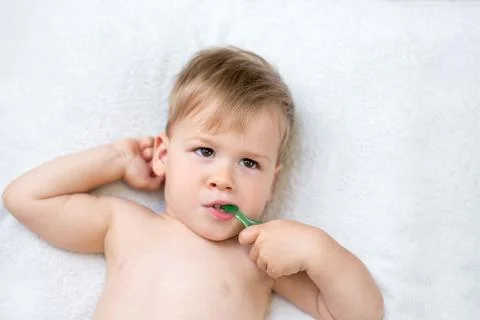 Two year old boy brushing his teeth Stock Photos