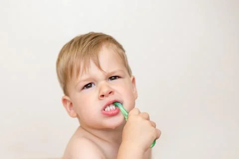Two year old boy brushing his teeth Stock Photos
