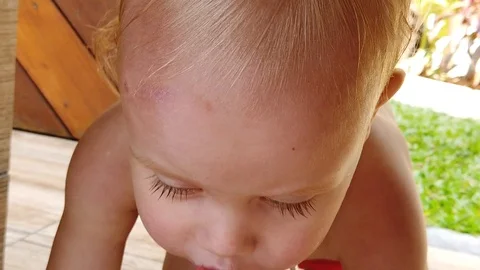  two year old boy creeps under the table, closeup, slow motion. Stock Footage 105053097