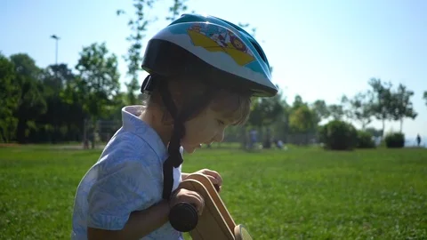 Two year old boy riding a bike on a sunny day in park Stock Footage 109223362