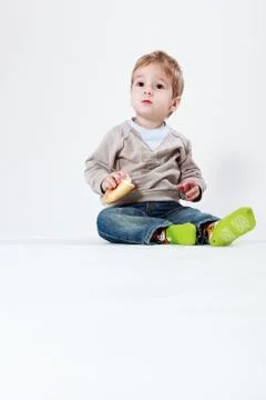 Two-year old boy with a roll Stock Photos