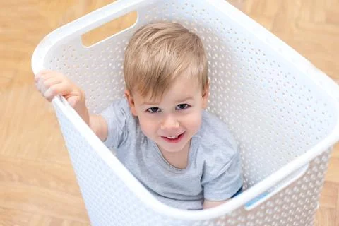 Two year old boy sitting in a box Stock Photos