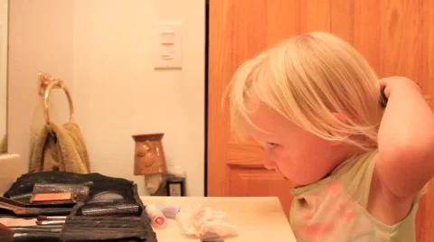 Two year old brushes her hair Stock Footage 41651823