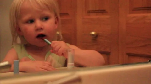 Two year old carefully applies liipstick Stock Footage 41651436