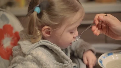 Two year old child eating porridge Stock Footage 81630278