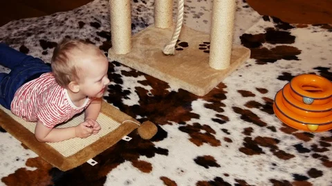 A two year old child lies on the floor and smiles. Stock Footage 103090585