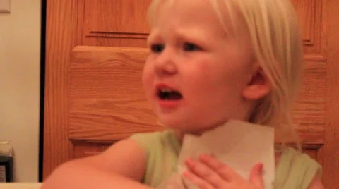 Two year old harshly wipes lips Stock Footage 41651439