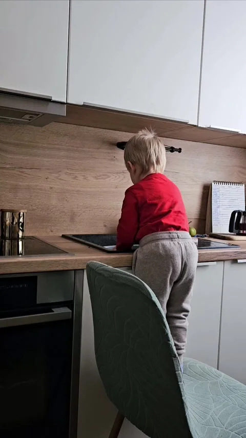 Two-Year-Old Helping Mom with Dishwashing, Learning to Clean and Assist at Home Stock Footage 306836970