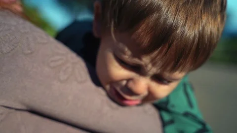 Two-year-old little son is naughty and crying on mom's hands Stock Footage 118551811