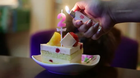 A two-year-old Poodle enjoys her birthday cake during a celebration Stock Footage 36143866