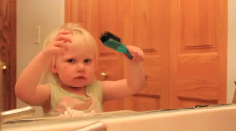 Two year old smiles big at her reflection Stock Footage 41651944