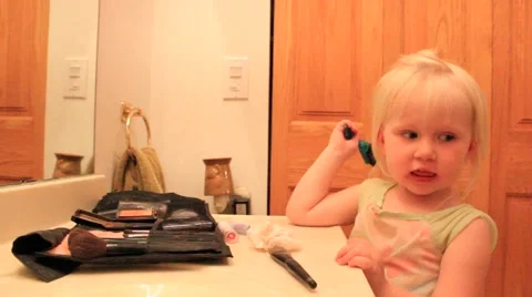 Two year old smooths down her bangs Stock Footage 41651865