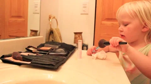 Two year old talks about her brush and lipstick Stock Footage 41651585