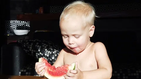 Two-year-old white-haired boy funny eating watermelon 스톡 동영상 110945851
