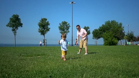 Two year toddler running after bubbles in a park enjoying life with laughs, Stock Footage 109221913
