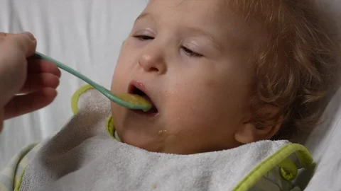 Two years old boy with cerebral palsy is fed by his mother at home. Special need Video stock 122614523