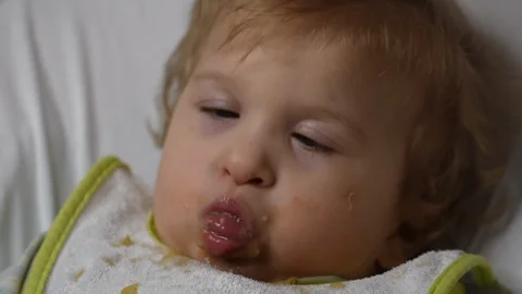 Two years old boy with cerebral palsy is fed by his mother at home. Special need Stock Footage 122614526