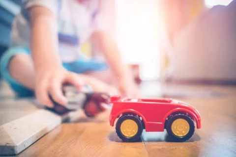 Two years old boy is playing with his toys indoors Foto stock