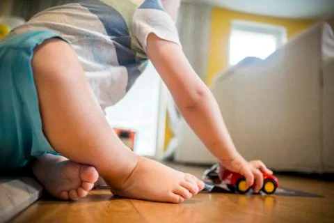 Two years old boy is playing with his toys indoors Stock Photos