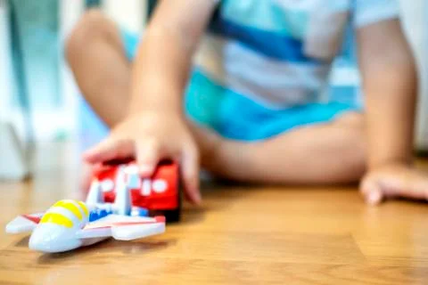 Two years old boy is playing with his toys indoors Stock Photos
