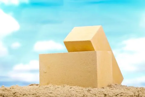 Two yellow ceramic bricks on the sand at the blue sky background Stock Photos