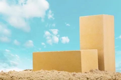 Two yellow ceramic bricks on the sand at the blue sky background Stock Photos