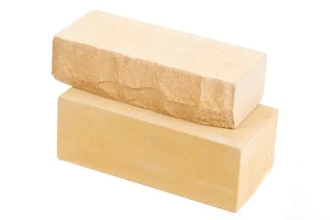 Two yellow ceramic bricks at the white background, isolated Foto stock