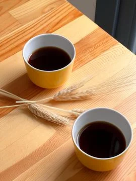 Two yellow coffee cups on the table Stock Photos