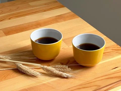 Two yellow coffee cups on the table Stock Photos