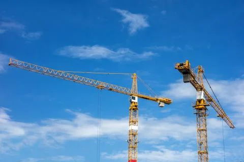Two yellow cranes constructiing a new building Stock Photos